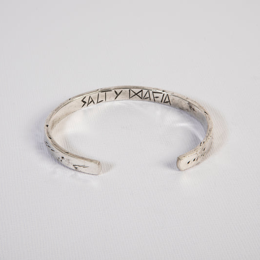 Bold and rugged men’s solid silver cuff bracelet, perfect for adventurers and ocean lovers.