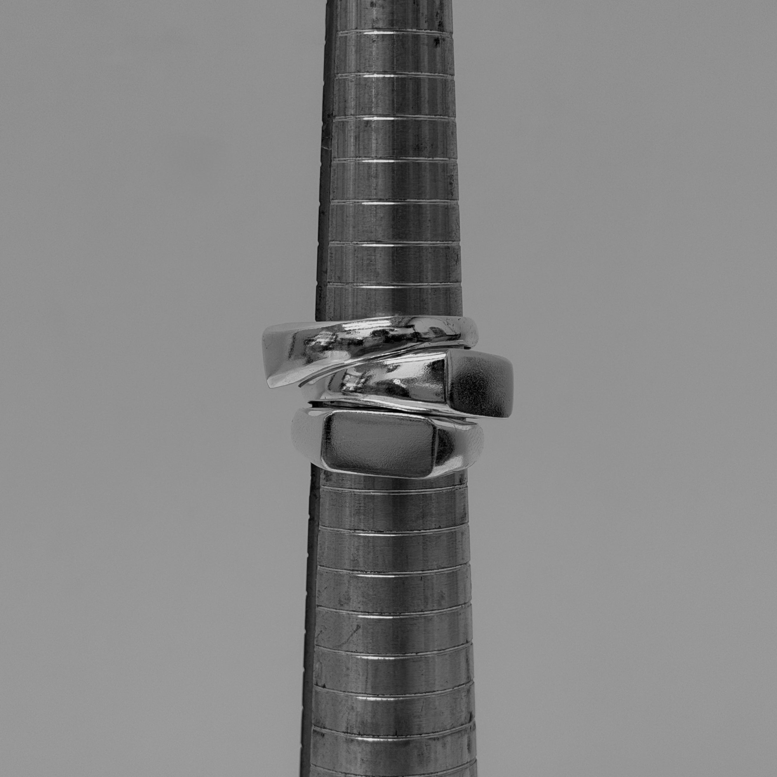 Close-up of a ring sizing rod with silver rings